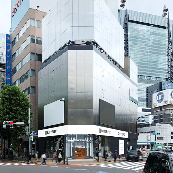 スーツセレクト新橋の画像。交差点コーナーに立地。側面に2枚の巨大モニター。ガラス張りの入り口。